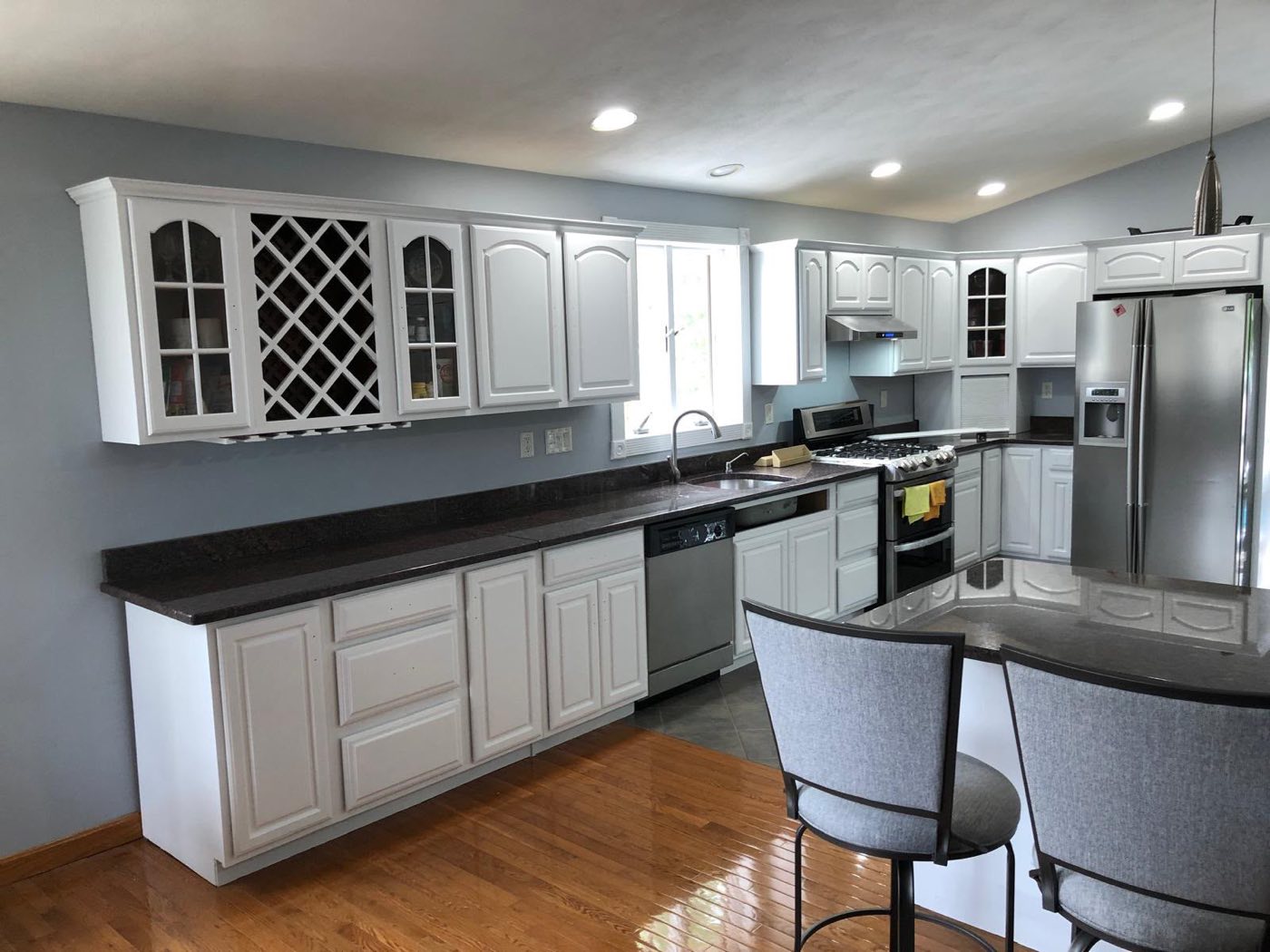 Same kitchen with cabinets refinished in white