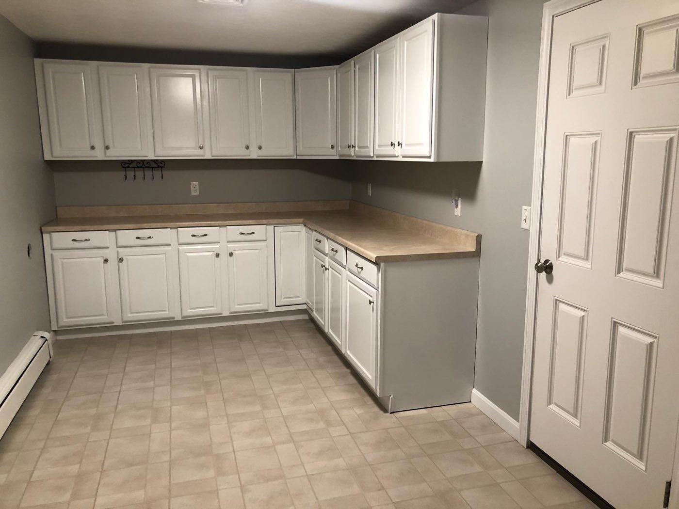 White cabinet kitchen with tile floor