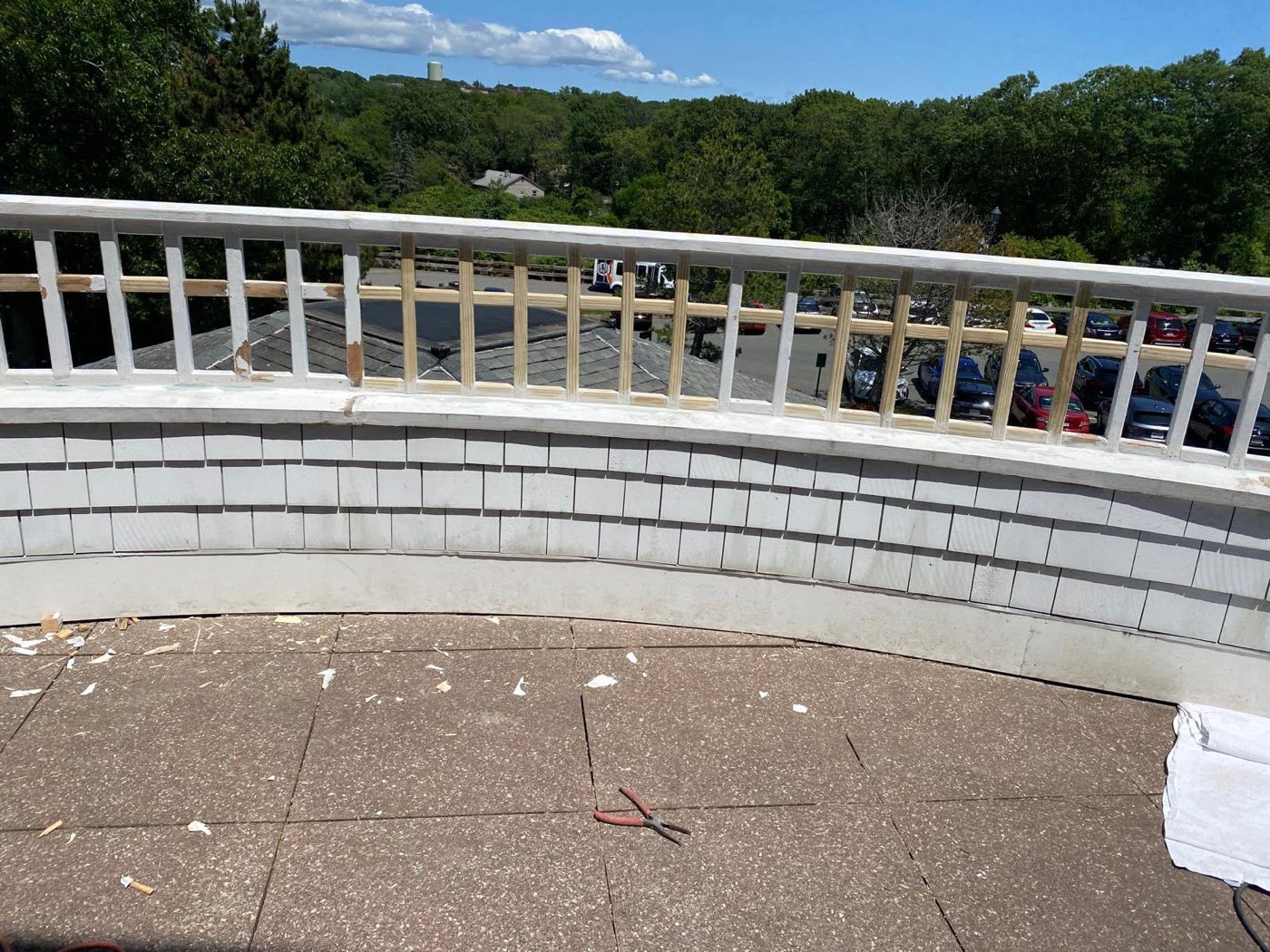 Rotted white balcony railing before repair