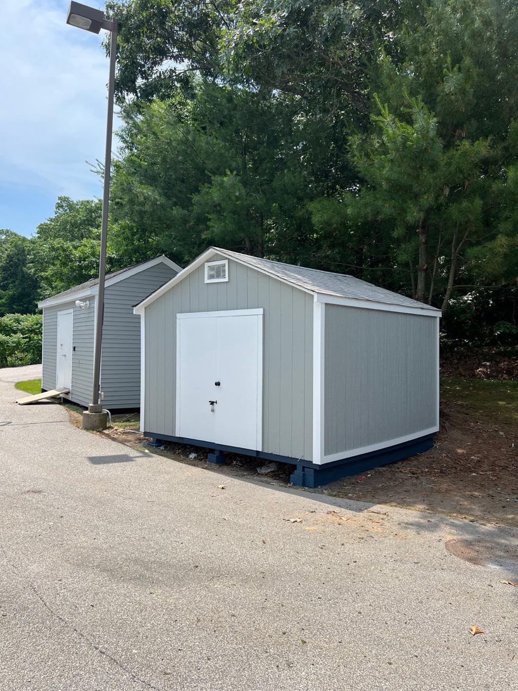 Finished gray shed with white trim